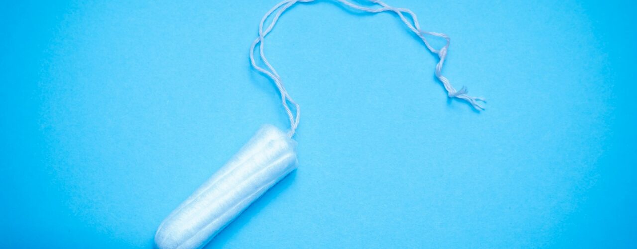 a plastic tube of toothpaste on a blue background